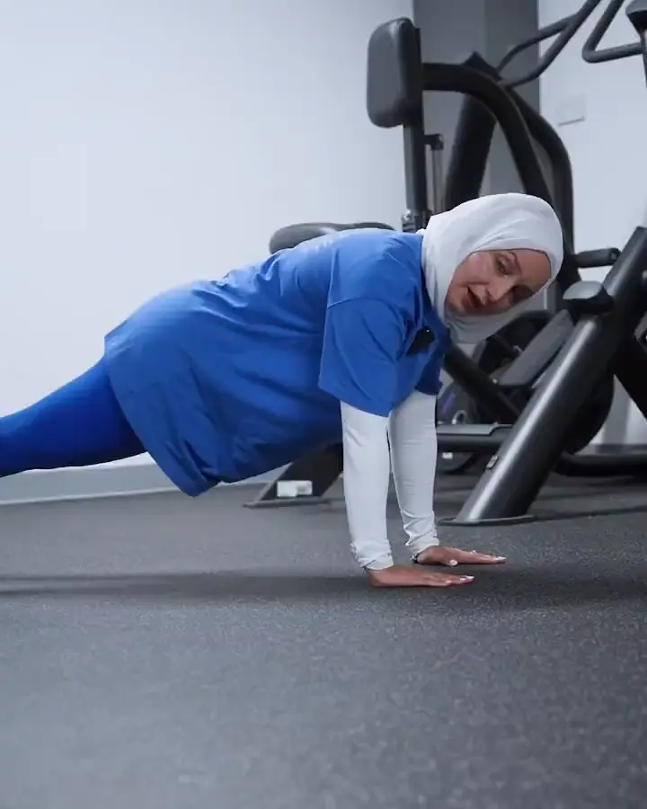 Najah in a plank on the gym floor, from her reel No push up? No problem!