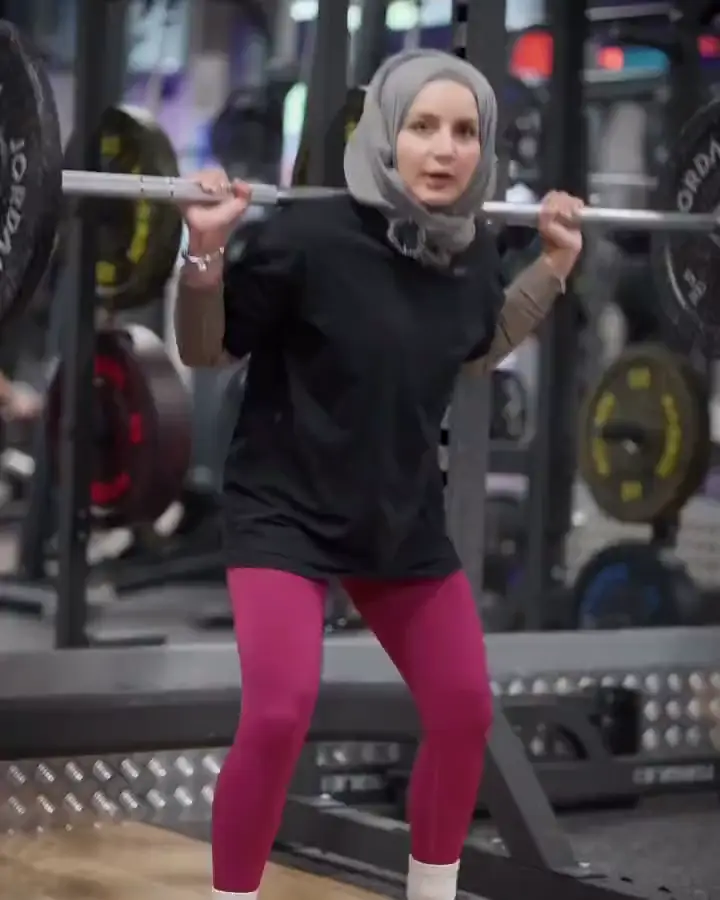 Najah squatting with the bar on her back, from her reel No mobility? No problem!